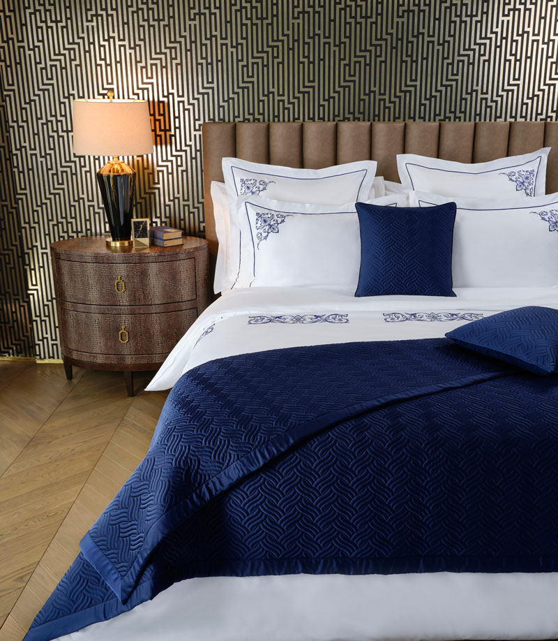 wallpaper of geometric patterns in darker colours to create a Masculine Bedroom